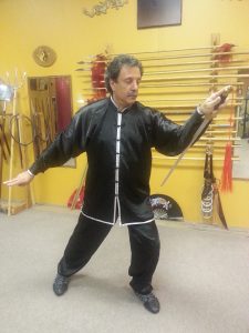Student in an open-hand stance, arms extended
