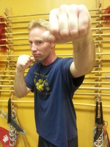 Student with fist extended forward in a guard stance