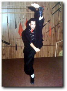 Student performing a high kick, black and white photo